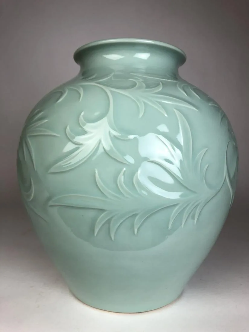 A very large porcelain baluster vase highly chased